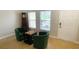 Living area with hardwood floors and green chairs at 18204 Ackerman Ave, Port Charlotte, FL 33948