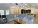 Spacious living room featuring a large sectional sofa and access to kitchen at 18204 Ackerman Ave, Port Charlotte, FL 33948