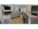 Open living room and kitchen with hardwood floors and breakfast bar at 18204 Ackerman Ave, Port Charlotte, FL 33948