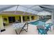 Inviting pool area with covered lanai, hammock, and comfortable seating at 18204 Ackerman Ave, Port Charlotte, FL 33948