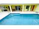 Clean swimming pool with tiled steps and surrounding patio at 18204 Ackerman Ave, Port Charlotte, FL 33948