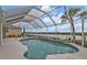 Inviting pool area with screened enclosure, offering water views at 18794 Ayrshire Cir, Port Charlotte, FL 33948