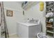 Clean laundry room with washer, dryer, and ample storage at 1971 Massachusetts Ave, Englewood, FL 34224