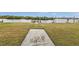 Backyard with grassy area and access to a dock at 226 Spring Lake Nw Blvd, Port Charlotte, FL 33952