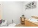 Clean bathroom with a corner sink and wicker storage at 226 Spring Lake Nw Blvd, Port Charlotte, FL 33952