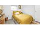 Bright bedroom with a mustard yellow comforter and gray floors at 226 Spring Lake Nw Blvd, Port Charlotte, FL 33952