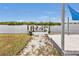 Wooden dock with seating overlooking the calm water at 226 Spring Lake Nw Blvd, Port Charlotte, FL 33952