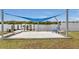 Relaxing waterfront dock area with shade sail and seating at 226 Spring Lake Nw Blvd, Port Charlotte, FL 33952