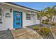 Inviting blue front door with a wreath, a dolphin accent, and a walkway at 226 Spring Lake Nw Blvd, Port Charlotte, FL 33952
