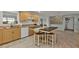 Kitchen with light wood cabinets, a large island, and a view of the dining area at 226 Spring Lake Nw Blvd, Port Charlotte, FL 33952
