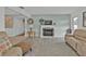 Tan couches and a fireplace in a living room with tile floors at 226 Spring Lake Nw Blvd, Port Charlotte, FL 33952