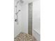 Walk-in shower with pebble floor and accent tile at 226 Spring Lake Nw Blvd, Port Charlotte, FL 33952