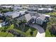 Aerial view of a single-Gathering home with a circular driveway, lush landscaping, and canal access at 2824 Caribbean Dr, Punta Gorda, FL 33950