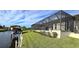 Landscaped backyard with canal views and screened patio at 2824 Caribbean Dr, Punta Gorda, FL 33950