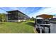 Screened patio, grassy yard, and canal-side boat lift at 2824 Caribbean Dr, Punta Gorda, FL 33950
