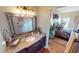 Bathroom with granite countertop, updated vanity, and large mirror at 2824 Caribbean Dr, Punta Gorda, FL 33950