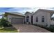 Exterior view of a single-story house with a two-car garage and manicured landscaping at 2824 Caribbean Dr, Punta Gorda, FL 33950