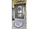 Front door entry with a circular mosaic tile and a welcome sign at 2824 Caribbean Dr, Punta Gorda, FL 33950