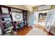 Home office features built-in shelving, a desk, and views into the kitchen at 2824 Caribbean Dr, Punta Gorda, FL 33950
