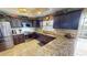 Modern kitchen with granite countertops, dark cabinets, and stainless steel appliances at 2824 Caribbean Dr, Punta Gorda, FL 33950