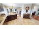 Kitchen with granite countertops and dark wood cabinets, open to dining area at 2824 Caribbean Dr, Punta Gorda, FL 33950