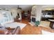 Open concept living area with hardwood floors, fireplace, and kitchen views at 2824 Caribbean Dr, Punta Gorda, FL 33950