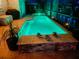 Night view of a relaxing pool and spa area with lighting at 2824 Caribbean Dr, Punta Gorda, FL 33950
