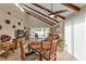 Dining area with wooden table and chairs, adjacent to living room at 3114 Magdalina Dr, Punta Gorda, FL 33950