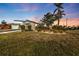 Charming house with a well-manicured lawn and mature trees at 3114 Magdalina Dr, Punta Gorda, FL 33950