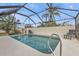 Relaxing screened-in pool area with patio chairs at 3114 Magdalina Dr, Punta Gorda, FL 33950