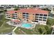 Aerial view of condo building with pool, patio area, and water access at 3322 Purple Martin Dr # 126, Punta Gorda, FL 33950