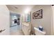 Updated bathroom with granite vanity and view of kitchen at 3322 Purple Martin Dr # 126, Punta Gorda, FL 33950