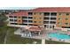 Community pool and patio area with lounge chairs at 3322 Purple Martin Dr # 126, Punta Gorda, FL 33950