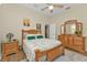 Bright bedroom with wood furniture and ceiling fan at 3411 Curacao Ct, Punta Gorda, FL 33950
