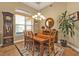 Bright dining room featuring a grandfather clock and large windows at 3411 Curacao Ct, Punta Gorda, FL 33950