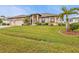 Beautiful one-story home with a large front yard and palm trees at 3411 Curacao Ct, Punta Gorda, FL 33950