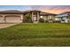 Beautiful home with three-car garage and lush lawn at 3411 Curacao Ct, Punta Gorda, FL 33950
