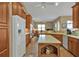Kitchen features wood cabinets, large island, and views into the living area at 3411 Curacao Ct, Punta Gorda, FL 33950