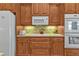 Modern kitchen with wood cabinets, updated appliances, and a breakfast bar at 3411 Curacao Ct, Punta Gorda, FL 33950