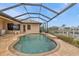 Kidney-shaped pool with screened enclosure and canal view at 3411 Curacao Ct, Punta Gorda, FL 33950