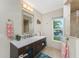 Bathroom with a modern vanity, granite countertops, and large mirror at 3412 Nighthawk Ct, Punta Gorda, FL 33950