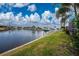 Beautiful view of the canal, boats, and lush green grass at 3412 Nighthawk Ct, Punta Gorda, FL 33950