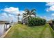 Landscaped yard with canal views and boat docks at 3412 Nighthawk Ct, Punta Gorda, FL 33950