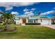 White house with green metal roof and landscaped yard at 3412 Nighthawk Ct, Punta Gorda, FL 33950