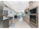 Modern kitchen with stainless steel appliances and a farmhouse sink at 3412 Nighthawk Ct, Punta Gorda, FL 33950