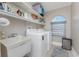 Laundry room with washer, dryer, utility sink, and shelving at 3412 Nighthawk Ct, Punta Gorda, FL 33950