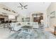 Spacious living room featuring a large sectional sofa and access to a waterfront patio at 3412 Nighthawk Ct, Punta Gorda, FL 33950