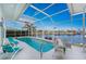 Inviting screened pool with lounge chairs and waterfront view at 3412 Nighthawk Ct, Punta Gorda, FL 33950