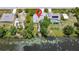 Aerial view of a charming home on a waterfront lot, surrounded by mature landscaping at 4267 Adelaide Ave, North Port, FL 34288