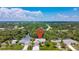 Spacious home's aerial view with a long driveway on a lot surrounded by lush landscapes at 4267 Adelaide Ave, North Port, FL 34288